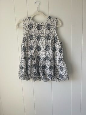 White Sleeveless Peplum Top with Black Floral Embroidery